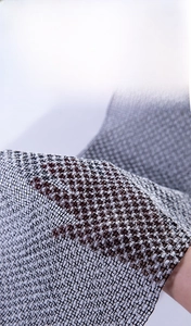 Detail showing the textured polyester exfoliating mesh and translucent black fabric weave