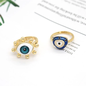 Golden Evil Eye adjustable copper rings with blue enamel and crystal accents