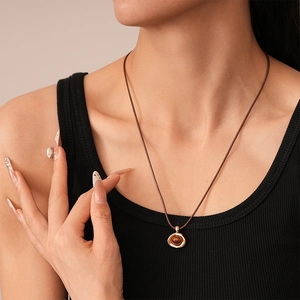 Detailed macro view of retro golden pendant with tiger eye stone on adjustable cord