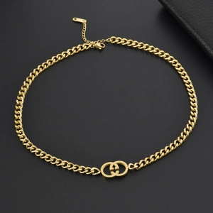 Detail of gold clover necklace showing lobster clasp and adjustable extension chain