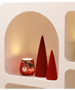 Detail of red flocked ceramic Christmas trees and a festive glitter candle holder with twine