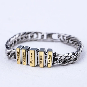 Macro view of two-tone Cuban chain bracelet with multiple engravable metal nameplates