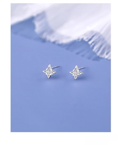 Close-up of S925 sterling silver four-pointed star stud earrings with cubic zirconia