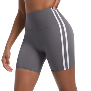 Detail of high-waist yoga shorts with side stripes and wide compression waistband