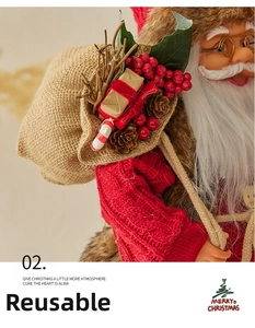 Close-up of Santa Claus doll wearing a red knit sweater with pine cones and gift bag