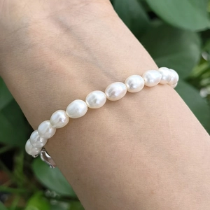 Macro shot of natural freshwater rice pearl bracelet with white luster on wrist
