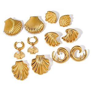 Collection of gold stainless steel shell earrings with pearls and zircon on white background