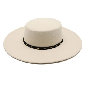 Detail of beige flat top wool fedora featuring a black band with gold and silver rivets