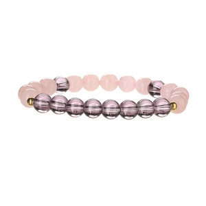 Macro shot of translucent pink and purple natural stone beads with gold accents on the bracelet