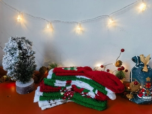 Detailed view of plush red and green Christmas socks with festive tree patterns