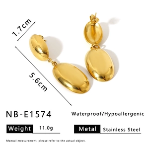 Macro detail of gold oval earrings showing 5.6cm length and waterproof stainless steel