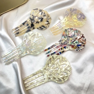 Elegant leopard print acetate hair side combs in five assorted colors on silk background