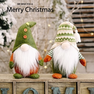 Christmas standing faceless gnomes with knitted hats on wooden box festive background