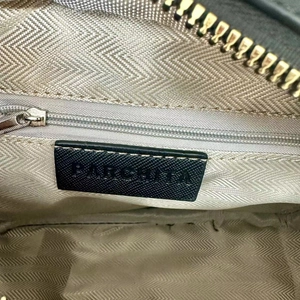 Detailed view of the PARCHITA handbag interior lining with zipper and brand label