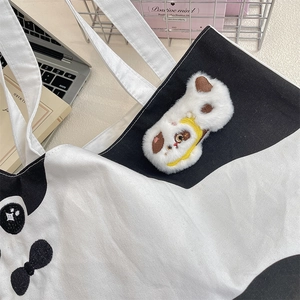 Detail of canvas tote bag with 3D plush puppy embroidery and black contrast trim