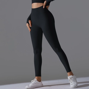 Detail of high waist seamless yoga pants and thumb hole long sleeve top in black
