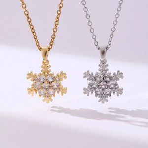 Macro detail of snowflake pendants with clear cubic zirconia in gold and silver plating