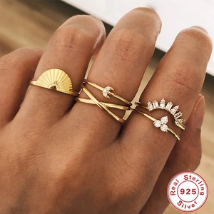 Set of four S925 sterling silver gold rings featuring sun, moon, crown and flower designs