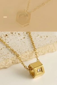 Macro shot of gold stainless steel hexagonal nut pendant with square cut zircon stone
