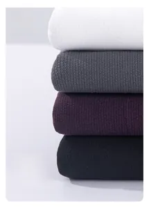 Close-up of ribbed elastic cotton knit sweaters in white, gray, purple and black colors