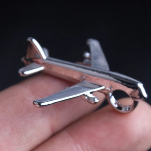 Detailed close-up of a polished silver airplane pendant for hip hop style necklaces