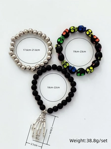 Gothic punk bracelet set with skull beads and bone hand charm on white background