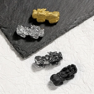 Close-up of 304 stainless steel Pixiu charms in gold, silver, black, and antique silver finish