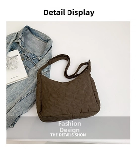 Detailed top view of dark brown quilted shoulder bag with 3D star embroidery and wide strap