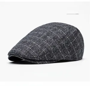 Close-up of grey plaid flat cap showing thick wool texture and classic British pattern