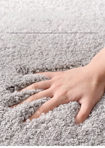 Detailed view of grey bathroom mat showing high-density thick pile and soft texture