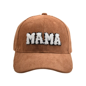 Close-up of MAMA white fleece embroidery on brown corduroy texture of the baseball cap