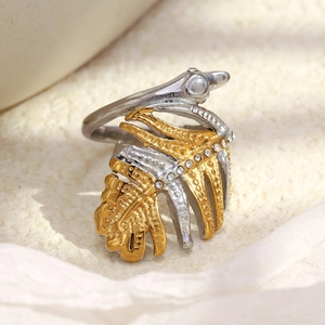Two-tone 18K gold plated leaf ring with sparkling crystals on a textured background
