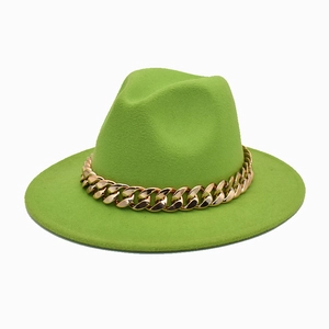 Close-up of bright green fedora hat with chunky gold metal chain link decoration