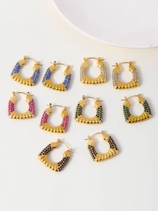 Detail view of gold U-shaped earrings with colorful pave zircon stones in multiple colors