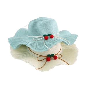 Women's straw sun hat with wavy brim, decorative knit cherries and cute bow detail