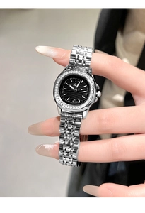 Close-up of luxury women's watch with diamond bezel and black wave dial on silver band