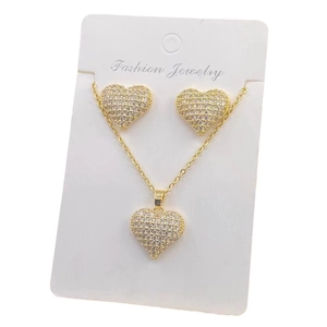 Golden heart jewelry set with necklace and stud earrings featuring sparkling crystals