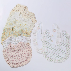 Floral cotton muslin baby bibs with ruffled edges and snap buttons in various colors