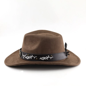 Detail of brown faux suede cowboy hat with metallic bull totem and studded leather band