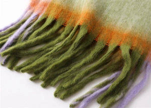 Close-up of multicolor gradient tassels on a warm faux cashmere pashmina scarf