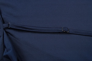 Macro detail of adjustable thin shoulder strap with metal ring on navy blue dress