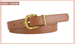 Close-up of camel leather belt featuring a polished golden bamboo style metal buckle