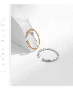 Detail view of S925 sterling silver and 18K gold open rings with delicate pavé diamonds