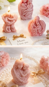 Detailed view of pink mother and child art candles with intricate carvings on lace