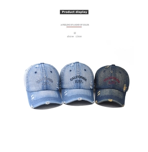 Detailed view of three distressed denim baseball caps with California Surf embroidery