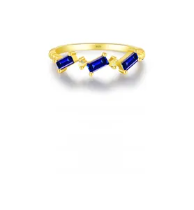 Detailed close-up of S925 engraving and rectangular blue gemstones on the gold ring