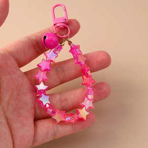 Close-up of pink star-shaped beaded keychain featuring a matching bell and metal clasp