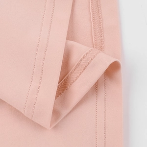 Close-up of pink long sleeve top showing detailed knit texture and high-quality stitching