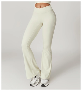 Detail of high waisted cream yoga flare pants with a crossover V-waistband design