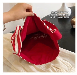 Detail of red and white striped canvas tote bag showing spacious red fabric interior